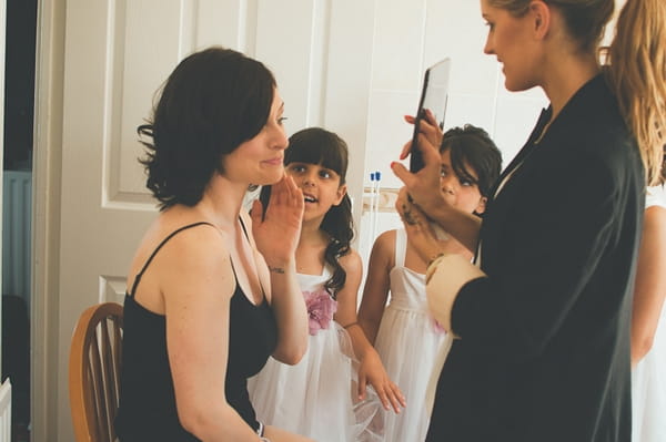 Bride looking in mirror - A Farm Wedding with a British Summer Theme