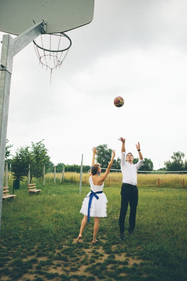 Groom shooting basketball - A Spring Themed Wedding in Hungary