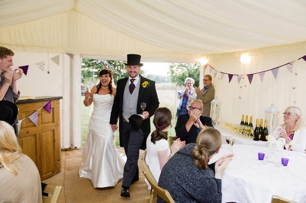 Bride and groom entering wedding breakfast