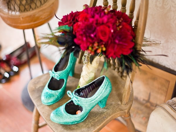 Light green wedding shoes and a red bouquet