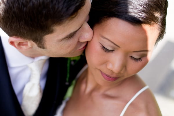 Groom kissing bride on cheek - Picture by Karli Harrison Photography
