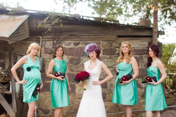 Bride with bridesmaids wearing green bridesmaid dresses