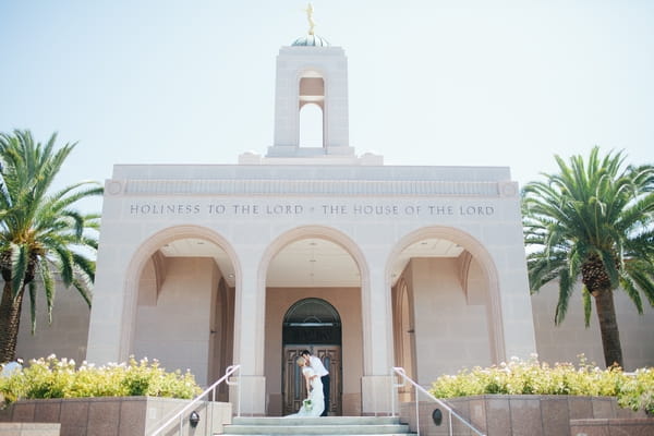 Bride and groom outside LDS Newport Beach Temple