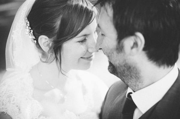 Black and white picture of bride and groom touching noses - Picture by Aaron Collett Photography