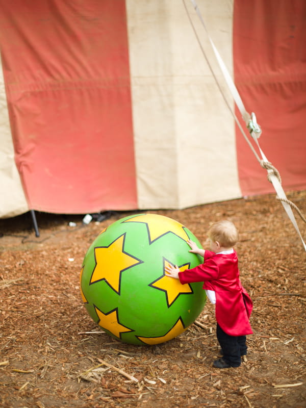 Pageboy pushing circus ball