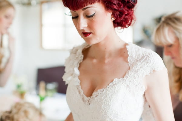 Redhead bride wearing lace wedding dress