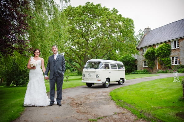 Bride and groom standing in front of a VW camper - Picture by Aaron Collett Photography