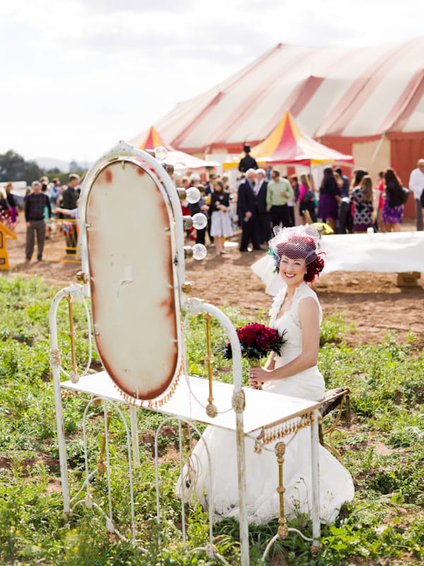 Bride sitting in front of circus mirror