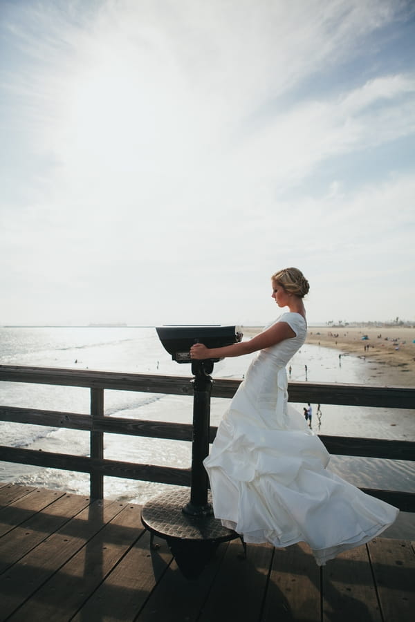 Bride leaning back on pier