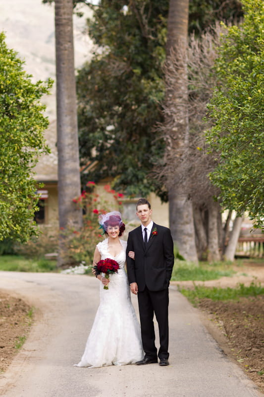 Bride and groom standing on path