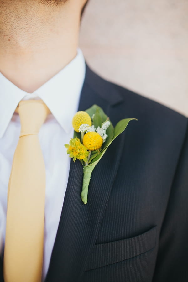 Yellow buttonhole on groom's jacket