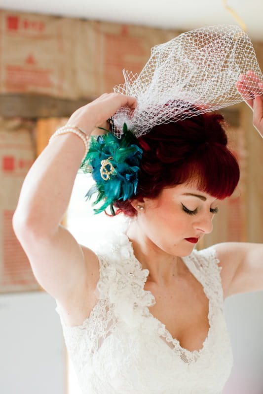 Bride putting on veil