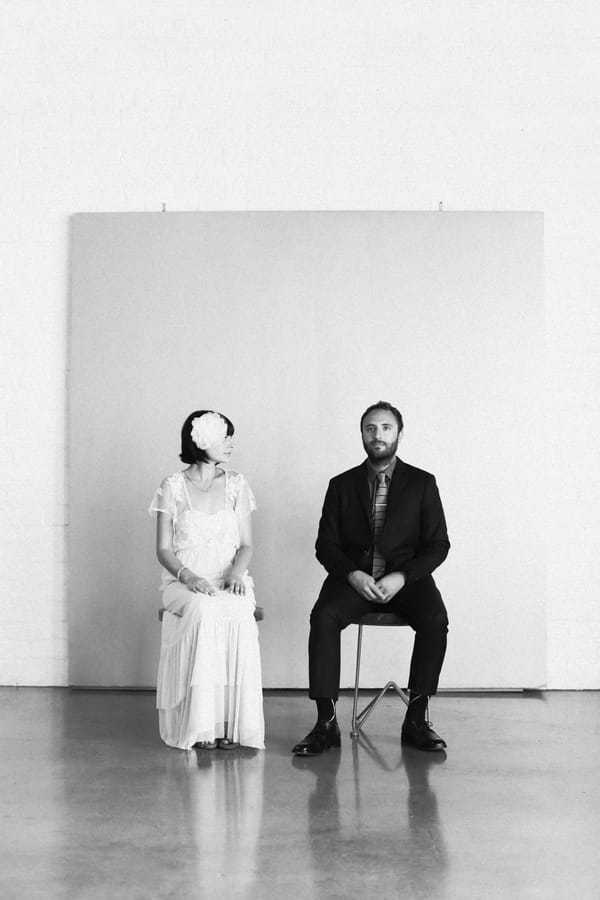 Bride and groom sitting on chairs