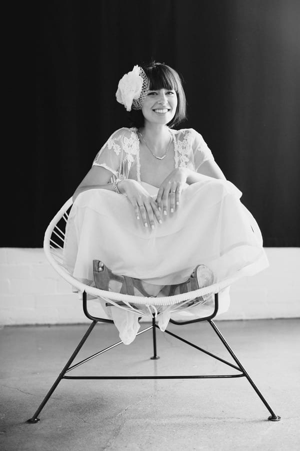 Bride sitting cross legged on chair