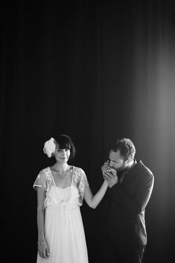 Groom kissing bride's hand