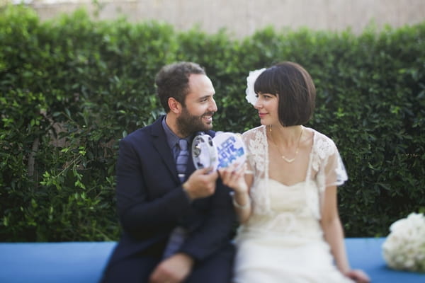 Bride and groom holding tambourine