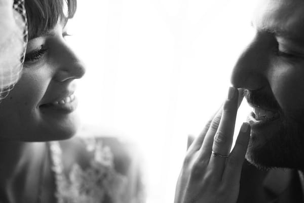 Bride touching groom's moustache