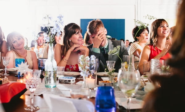 Wedding guest covering eyes at speech