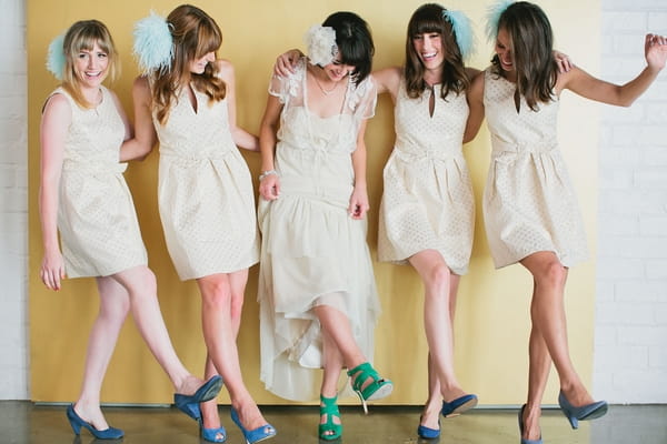 Bride and bridesmaids kicking legs