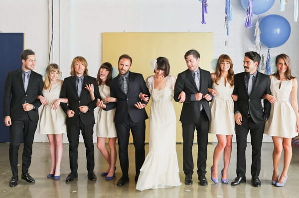 Bridal party with arms linked