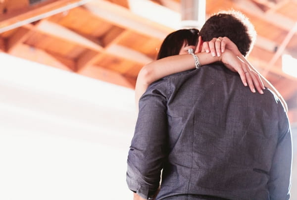 Bride hugging groom on dance floor