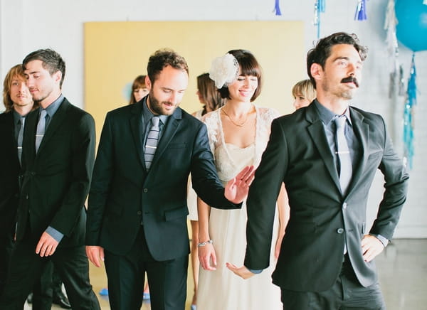 Groom hitting best man's hand