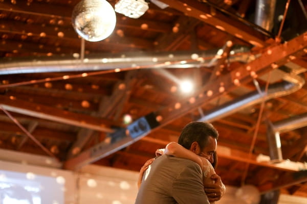 Bride hugging father on dance floor