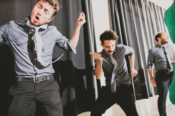 Groomsmen dancing at wedding