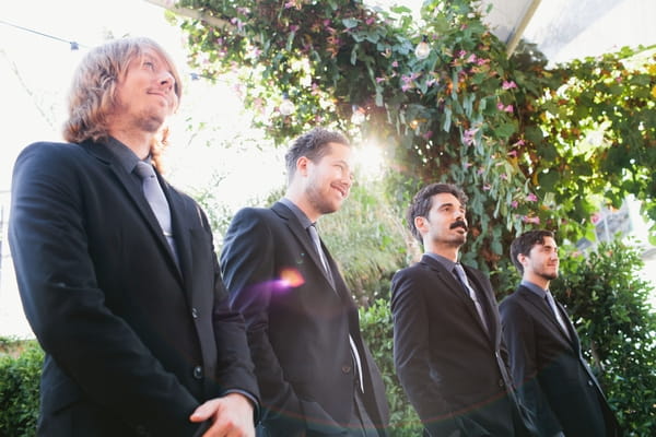 Groomsmen standing during wedding ceremony