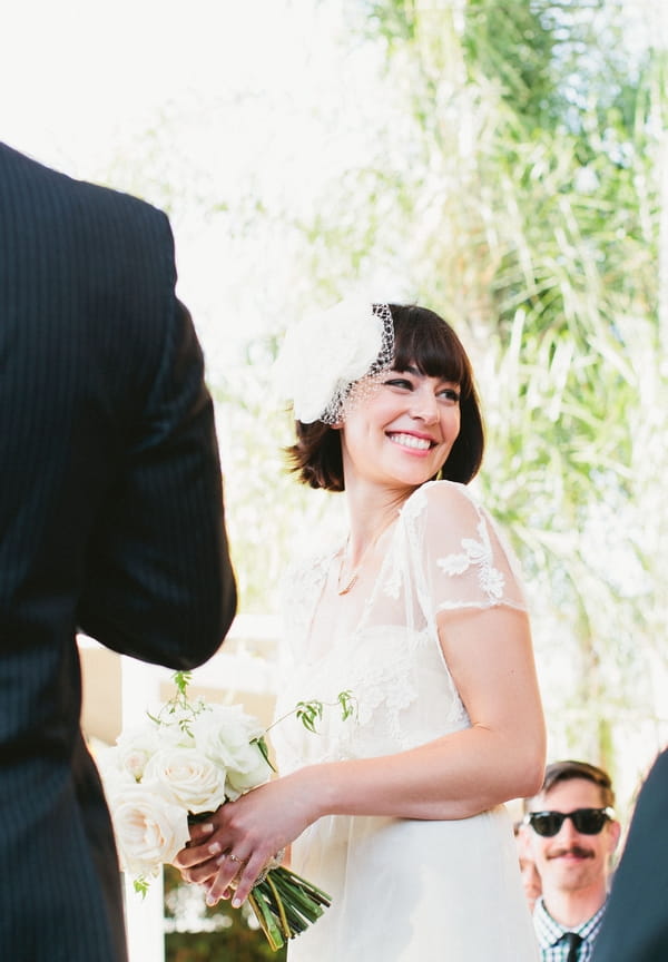 Bride looking over shoulder during wedding ceremony