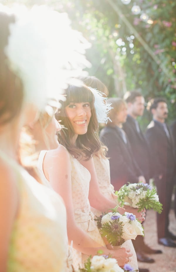 Bridesmaid smiling at bride