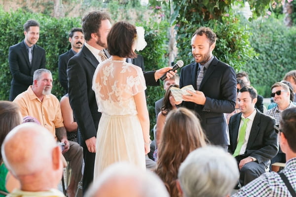 Groom reading wedding vows