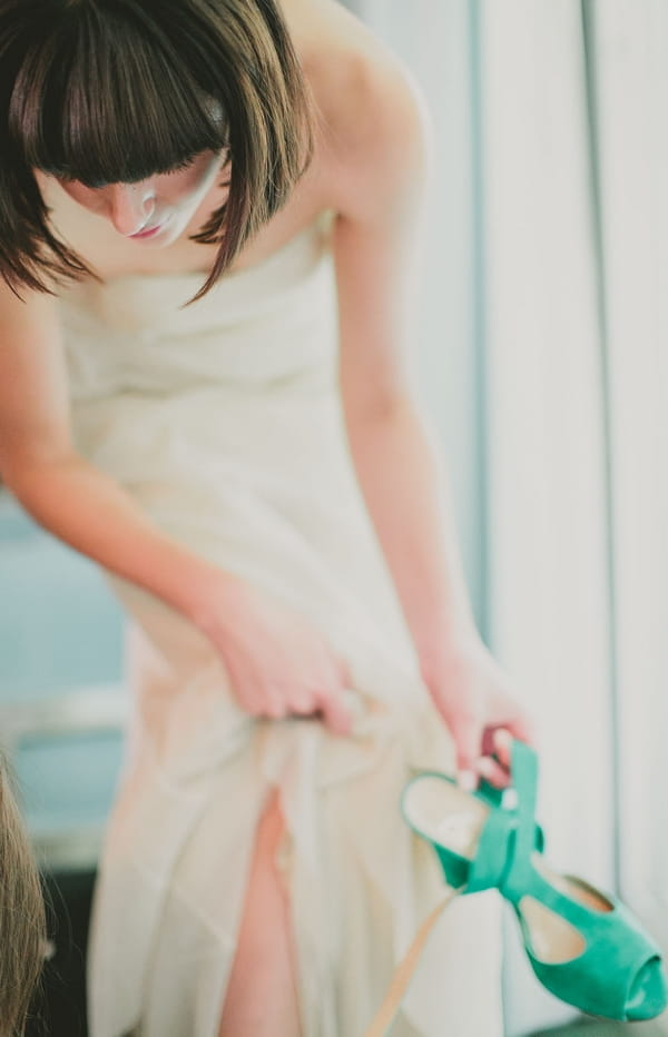 Bride holding green wedding shoe