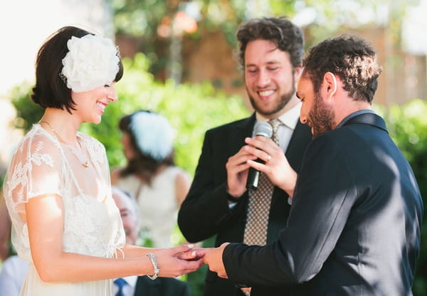 Bride and groom holding hands during wedding ceremony