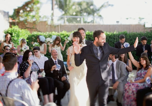 Bride and groom walk back down aisle as husband and wife