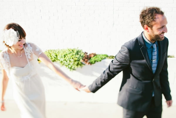 Groom leading bride by the hand