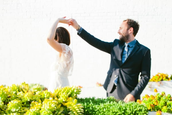 Groom twirling bride round