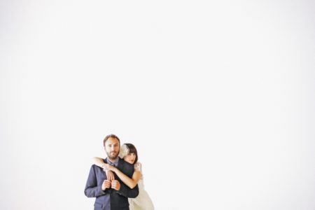 Bride with arms around groom's shoulders