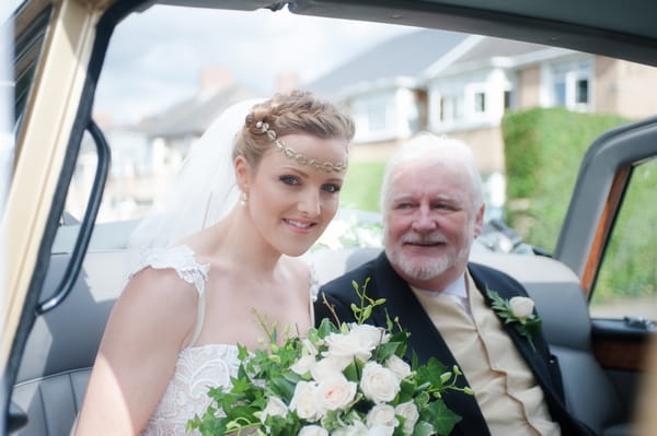 Bride with father in wedding car