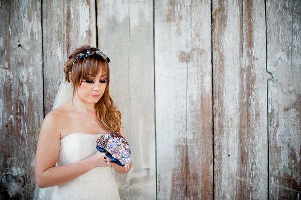 Bride holding brooch bouquet