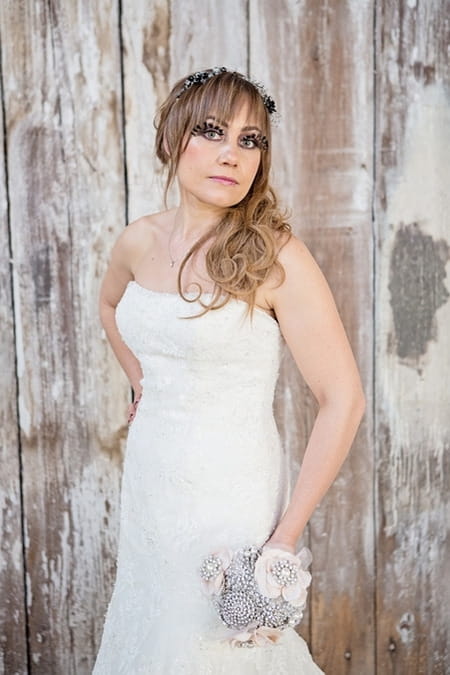 Bride posing with brooch bouquet