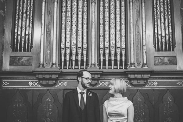 Bride and groom in front of organ pipes