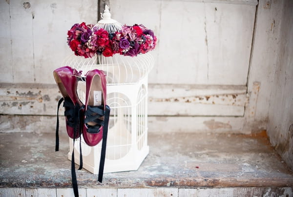 Shoes hanging from birdcage