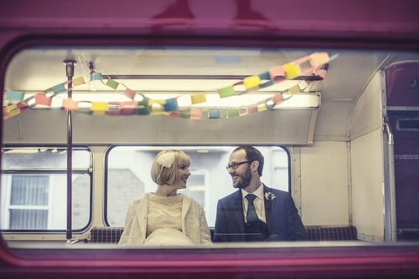 Bride and groom through bus window