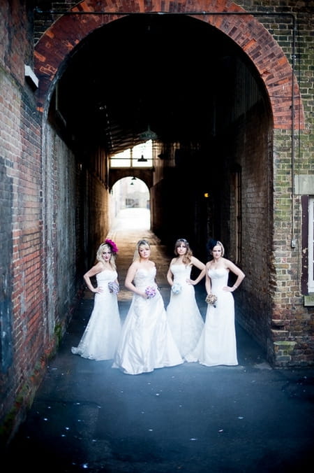 Four brides standing under arch