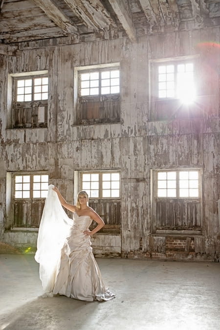 Bride holding up train on wedding dress