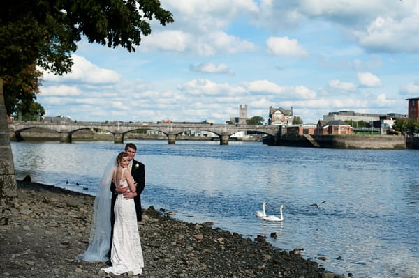 Bride and groom by river