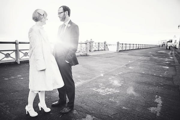 Black and white picture of bride and groom on Brighton seafront