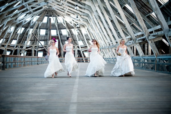 Four brides walking