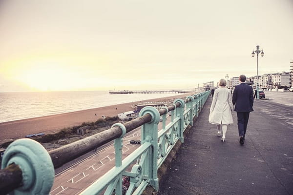 Bride and groom walking on Brighton seafront